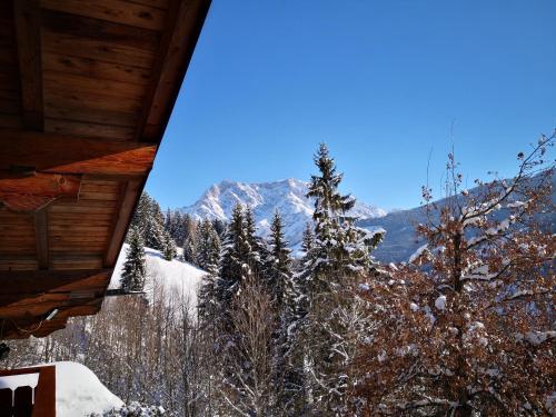 a view of a snowy mountain from a cabin at Ferienwohnung Klappacher in Maria Alm am Steinernen Meer