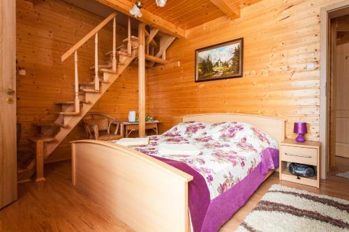 a bedroom with a bed in a log cabin at Pensjonat Antoś in Baligród