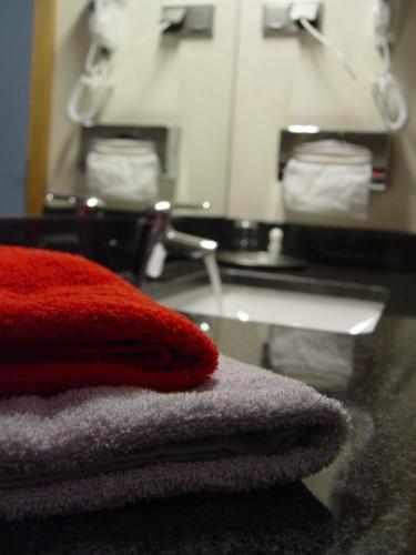 a towel sitting on a counter next to a sink at Hotel Goldener Hirsch in Suhl