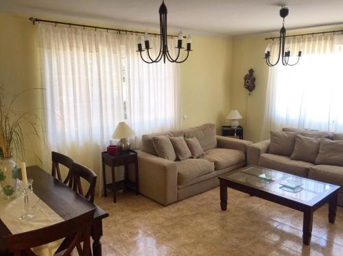 a living room with a couch and a table at Caprirural in Los Ángeles de San Rafael