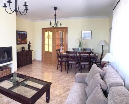 a living room with a couch and a table at Caprirural in Los Ángeles de San Rafael
