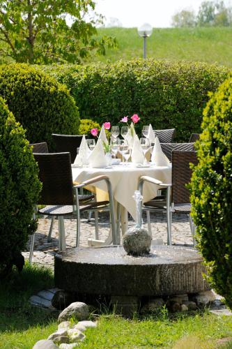 a table with chairs and a white table with flowers on it at Landhaus Tanner in Waging am See