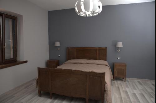 a bedroom with a bed and a chandelier at Agriturismo Il Parco in Nusco