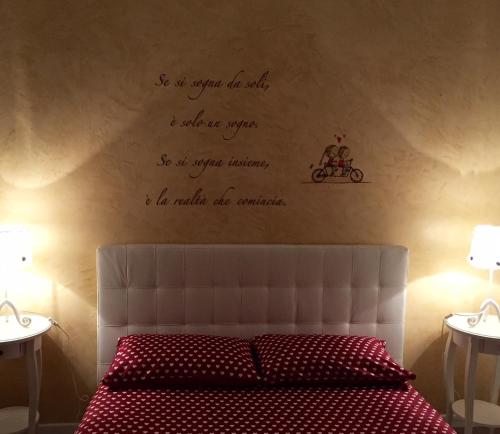 a bedroom with a bed with writing on the wall at affitto turistico San Pietro in Rome