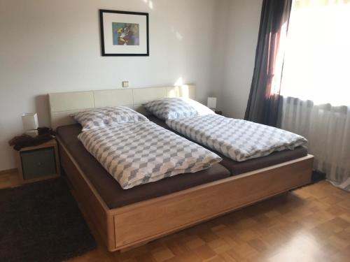 a bed with two pillows on it in a bedroom at Ferienwohnung Link in Limbach