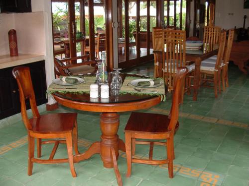 a wooden table and chairs in a dining room at Puri Ayu in Canggu