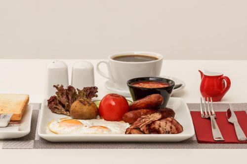 a plate of breakfast food with a cup of coffee at Art & Wine Boutique Hotel in Larnaka