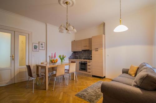 a living room with a couch and a dining room table at National Theater Ruterra Flat in Prague