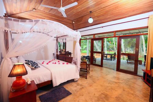 a bedroom with a bed with red roses on it at Selnara Private Luxury Villa and Ayurveda Spa in Bentota