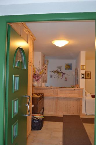 an open door into a living room with a kitchen at Agritur All'Olivo in Sover
