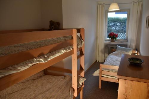 a bedroom with a bunk bed and a window at Alpenheim in Garmisch-Partenkirchen