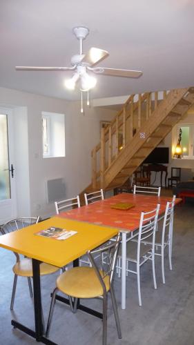 a dining room with a yellow table and chairs at Appartement Aux Armoiries de Sarlat in Sarlat-la-Canéda