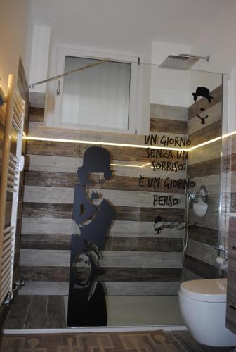 a bathroom with a wall with a mural of a staircase at Maison de Massimo cir 44 in Aosta
