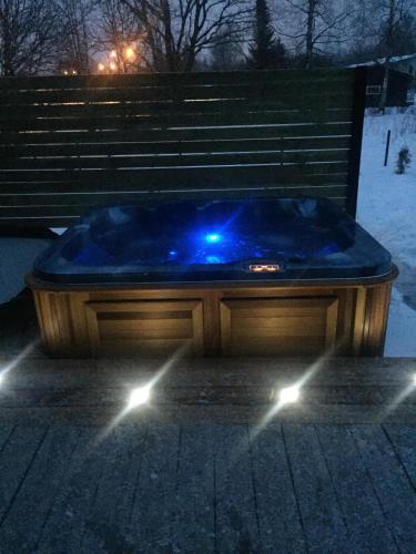 a blue tub sitting next to a bench at night at Isakaru Puhkemaja in Otepää