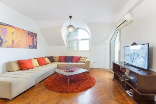 a living room with a couch and a tv at Old town Beauty Apartment with great view in Podgorica