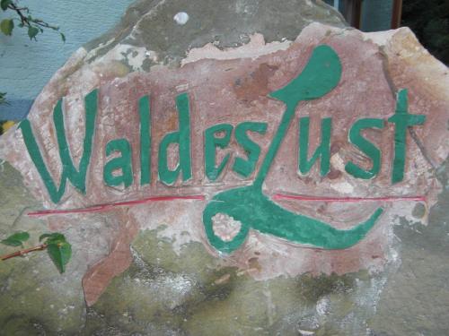 a sign on a rock with the word wallest at Gasthof Waldeslust in Böllenborn