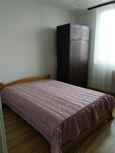 a bedroom with a bed and a dresser and a window at Veszprem city center in Veszprém