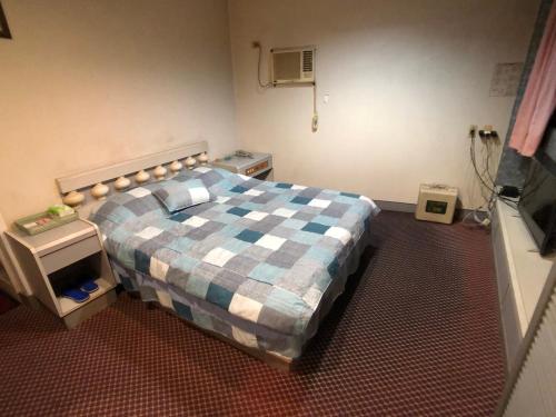 Cama ou camas em um quarto em Ya Shi Deng Hotel