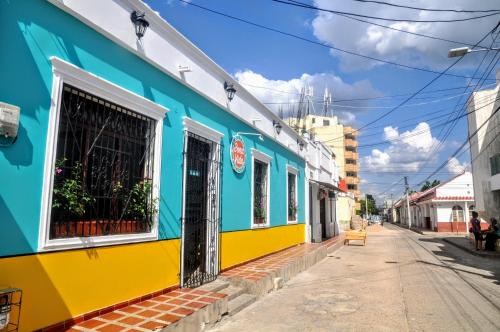 a colorful building on the side of a street at Bona Vida Hostel in Ríohacha