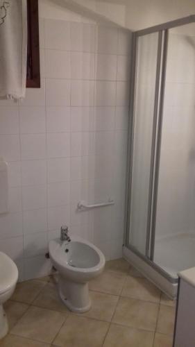 a bathroom with a toilet and a sink and a shower at Casa Matilde in Vercana