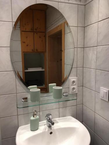 a bathroom with a sink and a mirror at PinkDeer in Hallstatt
