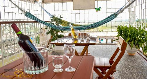 a bottle of wine sitting on a table with glasses at Hotel Ventura Isabel in Iquitos