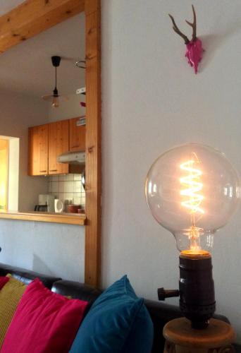 a lamp sitting on a table in a living room at PinkDeer in Hallstatt