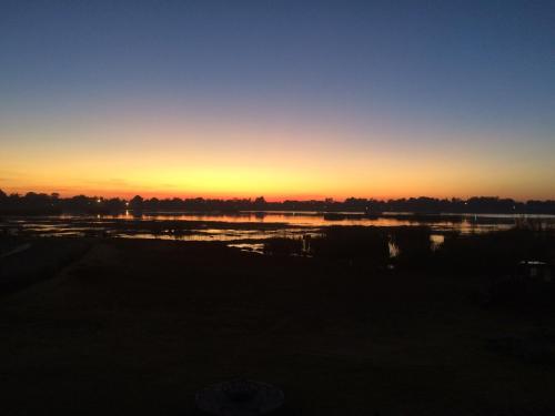 a sunset over a body of water at Bottom of Boden in Benoni