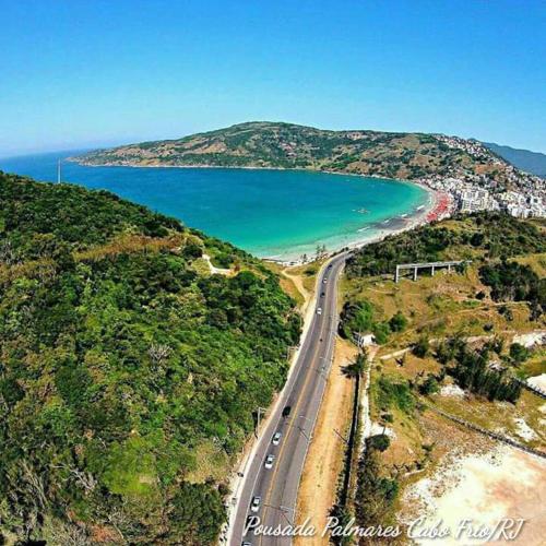 an aerial view of a road next to a beach at Pousada Palmares in Cabo Frio