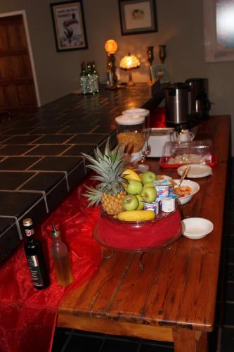 a table with a tray of fruit on a counter at Bottom of Boden in Benoni