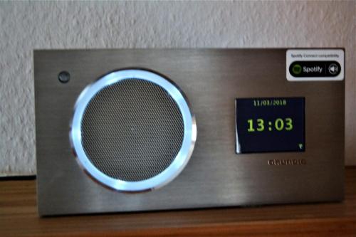 a clock sitting on top of a tv on a table at Haus Schimmelreiter in Greetsiel