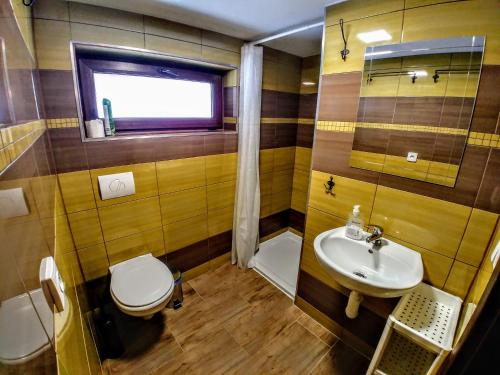 a bathroom with a toilet and a sink at Chata ZEBRA in Ružomberok