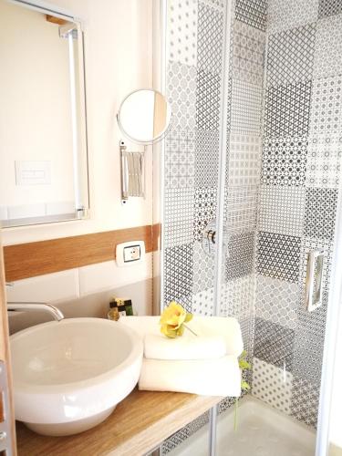 a bathroom with a sink and a shower at Casa Busari in Palermo