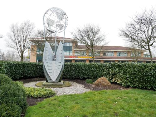 a sculpture of a surfboard in front of a building at Hotel het Oosten in Alphen aan den Rijn