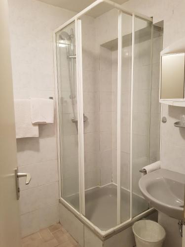 a bathroom with a shower and a toilet and a sink at Hotel Kronberg in Kronberg im Taunus