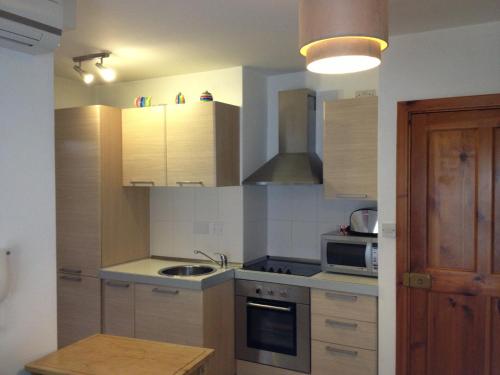 a kitchen with a sink and a stove top oven at Paceville Avenue Apartment in St Julian's