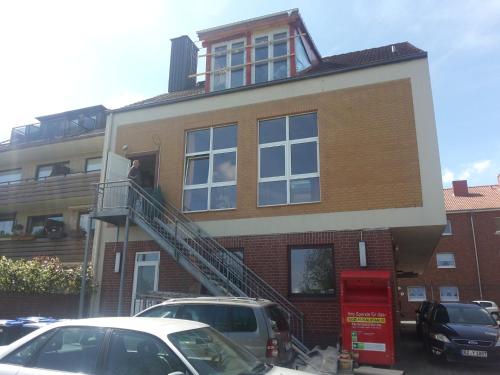 a man standing on the balcony of a building at Traumhafte Ferienwohnung in Ratzeburg