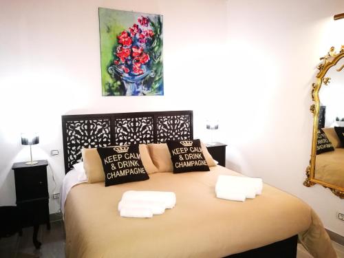 a bedroom with a bed with two pillows on it at Casa Busari in Palermo