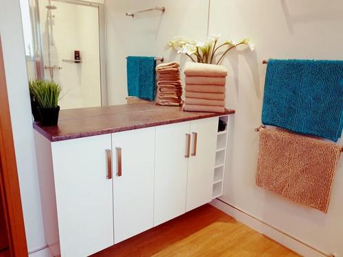 a bathroom with a white vanity with towels on it at Yvi's 2-3 Bedroom Town Apartment in Inverurie