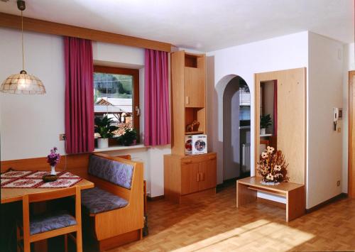 a living room with a table and a dining room at Appartement Wasserer in San Giovanni in Val Aurina