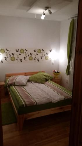 a bed in a bedroom with birds on the wall at Sofias Apartment in Bad Goisern