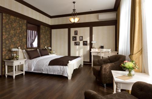 a bedroom with a bed and a living room at De Gaulle Boutique Hotel in Kharkiv