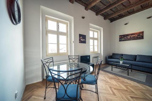 a living room with a glass table and chairs at St. George Apartments in Prague