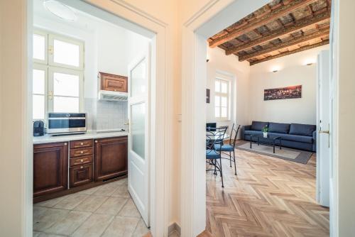 a kitchen and living room with a couch and a table at St. George Apartments in Prague