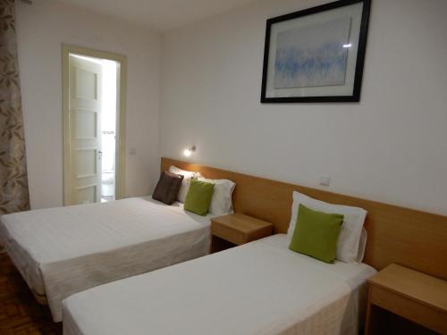 Postel nebo postele na pokoji v ubytování Guesthouse Coimbra City
