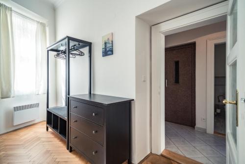 a dresser with a mirror on top of it in a room at St. George Apartments in Prague