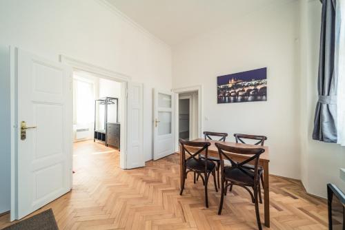 a dining room with a table and four chairs at St. George Apartments in Prague