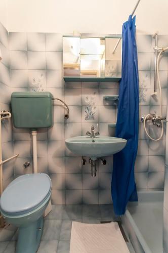 a bathroom with a toilet and a sink at Guest house Mediteran Relax in Makarska
