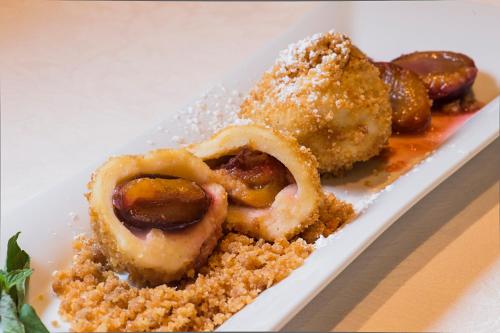 a plate of food with onion rings and sauce at Hotel Zum Pinzger in Stumm