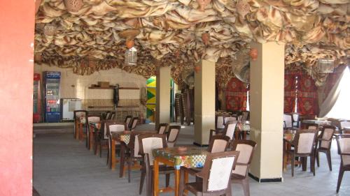 a restaurant with tables and chairs in a room at Sara Hotel Aswan in Aswan